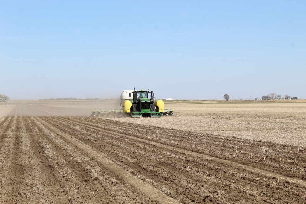 Tractor ready for winterizing on a barren corn field