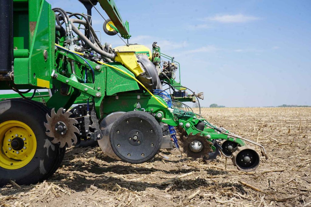 10 essential preseason planter checks for better yields blog header image showing tractor in a field